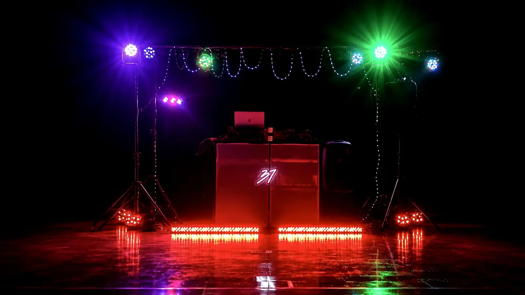 The DJ Studio 37 booth built and lit before doors, lighting stands either side of the floor