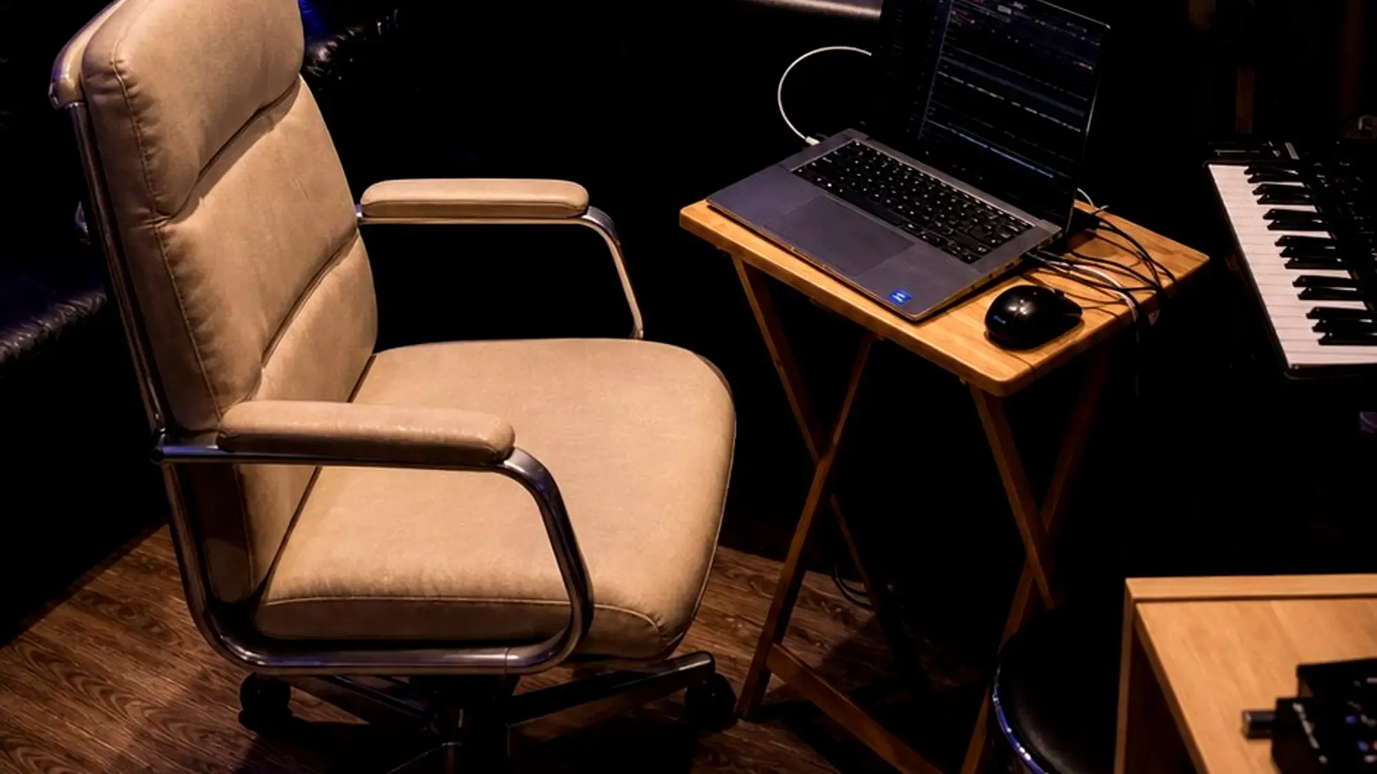 The control room: a Midas M32 console, monitors and a session open, with the live room through the glass