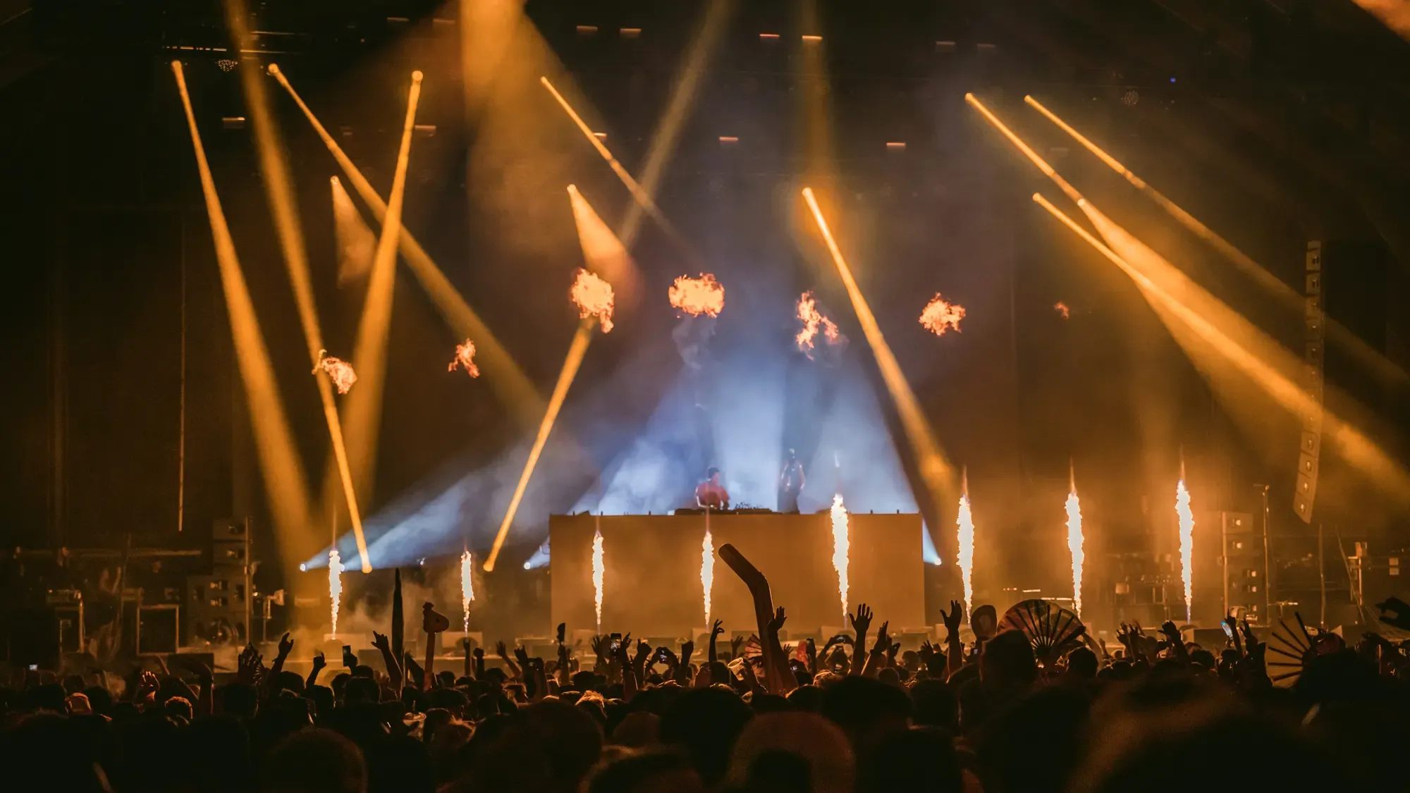 Festival main stage with beam fixtures and flame effects