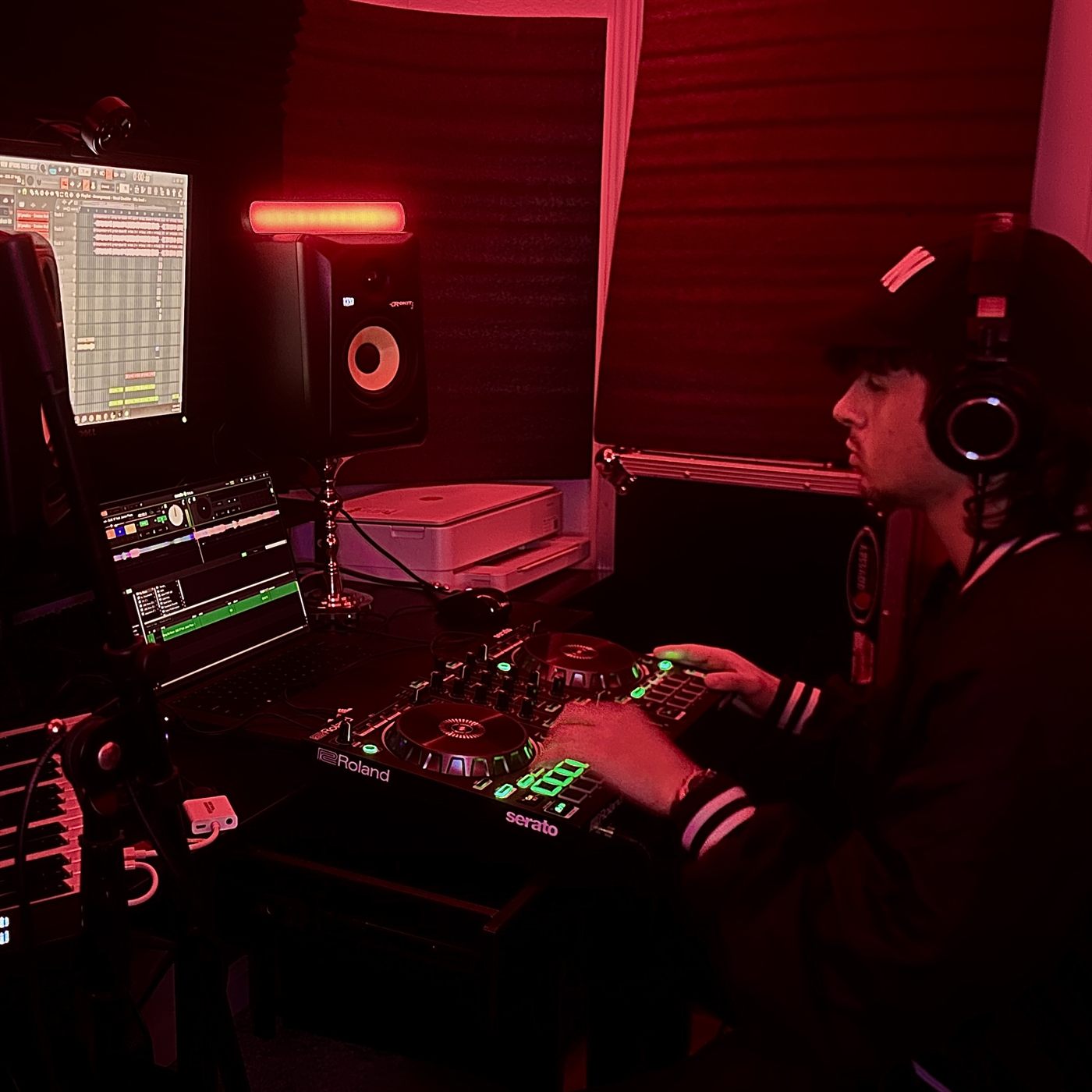 David making a beat at the desk, headphones on, lit red